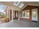 This cozy covered patio features skylights, white pillars, and brick accents at 112 Trellingwood Dr, Morrisville, NC 27560