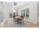 Bright dining room features large windows, modern chandelier, and stylish rug at 112 Trellingwood Dr, Morrisville, NC 27560