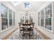 Bright dining room features large windows, modern chandelier, and stylish rug at 112 Trellingwood Dr, Morrisville, NC 27560