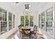 Sunlit dining room featuring a chandelier, multiple windows, and hardwood floors at 112 Trellingwood Dr, Morrisville, NC 27560