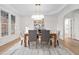 Bright dining room with hardwood floors, a modern chandelier, and large windows for plenty of natural light at 112 Trellingwood Dr, Morrisville, NC 27560