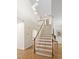 Bright home entryway with wood floors, staircase, and a view of the pendant lights at 112 Trellingwood Dr, Morrisville, NC 27560
