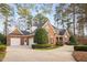Attractive brick house featuring an attached garage, side entryway and elegant landscaping in a serene setting at 112 Trellingwood Dr, Morrisville, NC 27560