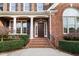 Detailed view of brick home's entrance showcasing columns and arched window at 112 Trellingwood Dr, Morrisville, NC 27560