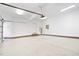 Clean, bright garage with epoxy flooring, brick trim, and convenient side door access to the exterior at 112 Trellingwood Dr, Morrisville, NC 27560