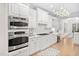 Spacious kitchen with stainless steel appliances, white cabinets, and hardwood floors for a modern look at 112 Trellingwood Dr, Morrisville, NC 27560