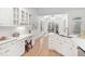 Bright kitchen with white cabinets, quartz countertops, and a built-in desk area at 112 Trellingwood Dr, Morrisville, NC 27560