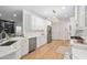 Bright kitchen with white cabinets, stainless steel appliances, and an open layout to the dining area at 112 Trellingwood Dr, Morrisville, NC 27560