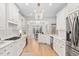 Elegant kitchen with white cabinets, modern lighting, and an open layout to the dining area for easy entertaining at 112 Trellingwood Dr, Morrisville, NC 27560