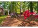 Landscaping with colorful azalea bushes bordering a white pergola and wrought iron gate adds beauty at 112 Trellingwood Dr, Morrisville, NC 27560