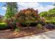 Landscaped yard featuring a colorful maple tree, roses and other plants creates an inviting outdoor space at 112 Trellingwood Dr, Morrisville, NC 27560
