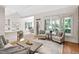 Open-concept living area with bar seating, large windows, and access to dining room at 112 Trellingwood Dr, Morrisville, NC 27560