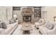 Living room with a stone fireplace, built-in bookshelves, and comfortable seating for a relaxing space at 112 Trellingwood Dr, Morrisville, NC 27560