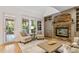 Inviting living room with a stone fireplace, built-in shelves, and natural light at 112 Trellingwood Dr, Morrisville, NC 27560