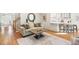 Bright living room featuring neutral decor, a decorative mirror, and hardwood floors at 112 Trellingwood Dr, Morrisville, NC 27560