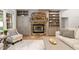 Cozy living room showcasing a stone fireplace with built-in bookshelves and cabinets at 112 Trellingwood Dr, Morrisville, NC 27560