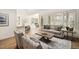 Open-concept living room with a cozy couch, large windows, and an open floor plan to the dining area at 112 Trellingwood Dr, Morrisville, NC 27560