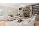 Comfortable living room with a stone fireplace, built-in shelves, and neutral tones for a relaxing atmosphere at 112 Trellingwood Dr, Morrisville, NC 27560