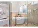 Bathroom features a soaking tub, tile surround and glass shower door at 112 Trellingwood Dr, Morrisville, NC 27560