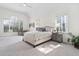 Bright bedroom features a large window, ceiling fan and neutral decor at 112 Trellingwood Dr, Morrisville, NC 27560