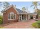 Beautiful brick home featuring a spacious covered patio and well-manicured landscaping at 112 Trellingwood Dr, Morrisville, NC 27560