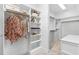 A spacious walk-in closet provides ample storage with bright white built-in shelving and carpeted floors at 112 Trellingwood Dr, Morrisville, NC 27560