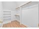 Spacious walk-in closet with custom shelving and wooden floors offers ample storage at 112 Trellingwood Dr, Morrisville, NC 27560