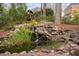 Rock waterfall creates a tranquil backyard pond, set within natural landscaping at 112 Trellingwood Dr, Morrisville, NC 27560