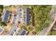 Aerial view of townhome community surrounded by mature trees and parking areas at 116 Anterbury Dr, Apex, NC 27502