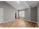 This is a spacious bedroom with light gray paint, a large window and laminate flooring at 116 Anterbury Dr, Apex, NC 27502