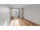 Bright bedroom with neutral walls, hardwood floors, lots of natural light and shelving at 116 Anterbury Dr, Apex, NC 27502