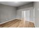 This is a large bedroom with light gray paint, white doors, and laminate flooring at 116 Anterbury Dr, Apex, NC 27502