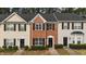 Charming townhomes featuring varied facades, dark shutters, and manicured landscaping at 116 Anterbury Dr, Apex, NC 27502