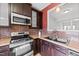 Kitchen with dark cabinets, stainless steel appliances, and tile backsplash at 116 Anterbury Dr, Apex, NC 27502