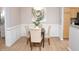 Cozy dining area featuring elegant wainscoting, modern lighting, and stylish table setting at 1301 Durlain Dr # 108, Raleigh, NC 27614