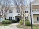 Inviting condo exterior with well-maintained landscaping, painted brick and sidewalk to entrance at 1301 Durlain Dr # 108, Raleigh, NC 27614