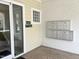 Building entrance featuring mailboxes and unit listings by a textured brick wall and neutral exterior at 1301 Durlain Dr # 108, Raleigh, NC 27614