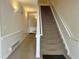 Well-lit hallway with carpeted stairs and trim that guides you to other sections of the building at 1301 Durlain Dr # 108, Raleigh, NC 27614