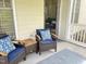 Relaxing patio with two chairs, a small table, and a door that welcomes you to come in at 1301 Durlain Dr # 108, Raleigh, NC 27614