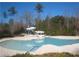 Community pool with waterslide surrounded by mature trees offers a refreshing oasis for residents at 1301 Durlain Dr # 108, Raleigh, NC 27614