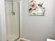 This cozy shower features glass doors and decorative wall art to add visual appeal at 1301 Durlain Dr # 108, Raleigh, NC 27614