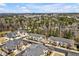 Beautiful aerial view of townhome community with mature trees and a view of the city skyline on a sunny day at 138 Tressel Way, Durham, NC 27707