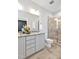 Bathroom featuring a granite vanity, large mirror, toilet, and glass-enclosed shower at 138 Tressel Way, Durham, NC 27707