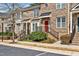 Charming brick townhomes with well-manicured landscaping and black awnings at 138 Tressel Way, Durham, NC 27707