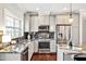 Modern kitchen with stainless steel appliances, gray cabinets, granite countertops, and tile backsplash at 138 Tressel Way, Durham, NC 27707