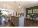 Open concept kitchen with island and seating that opens up to the dining area and living area at 138 Tressel Way, Durham, NC 27707