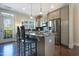 Kitchen with stainless appliances, a center island with barstool seating, and access to the back yard at 138 Tressel Way, Durham, NC 27707