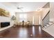 Spacious living room featuring hardwood floors, a ceiling fan, a modern fireplace, and stairs to the upper level at 138 Tressel Way, Durham, NC 27707