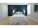 Comfortable bedroom with a dark accent wall, plush carpeting, shuttered windows and neutral decor at 138 Tressel Way, Durham, NC 27707