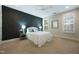 A serene main bedroom with a black accent wall, ceiling fan, and bright windows with shutters at 138 Tressel Way, Durham, NC 27707